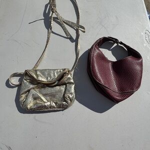 2 WOMENS small handbags. One gold and one burgundy